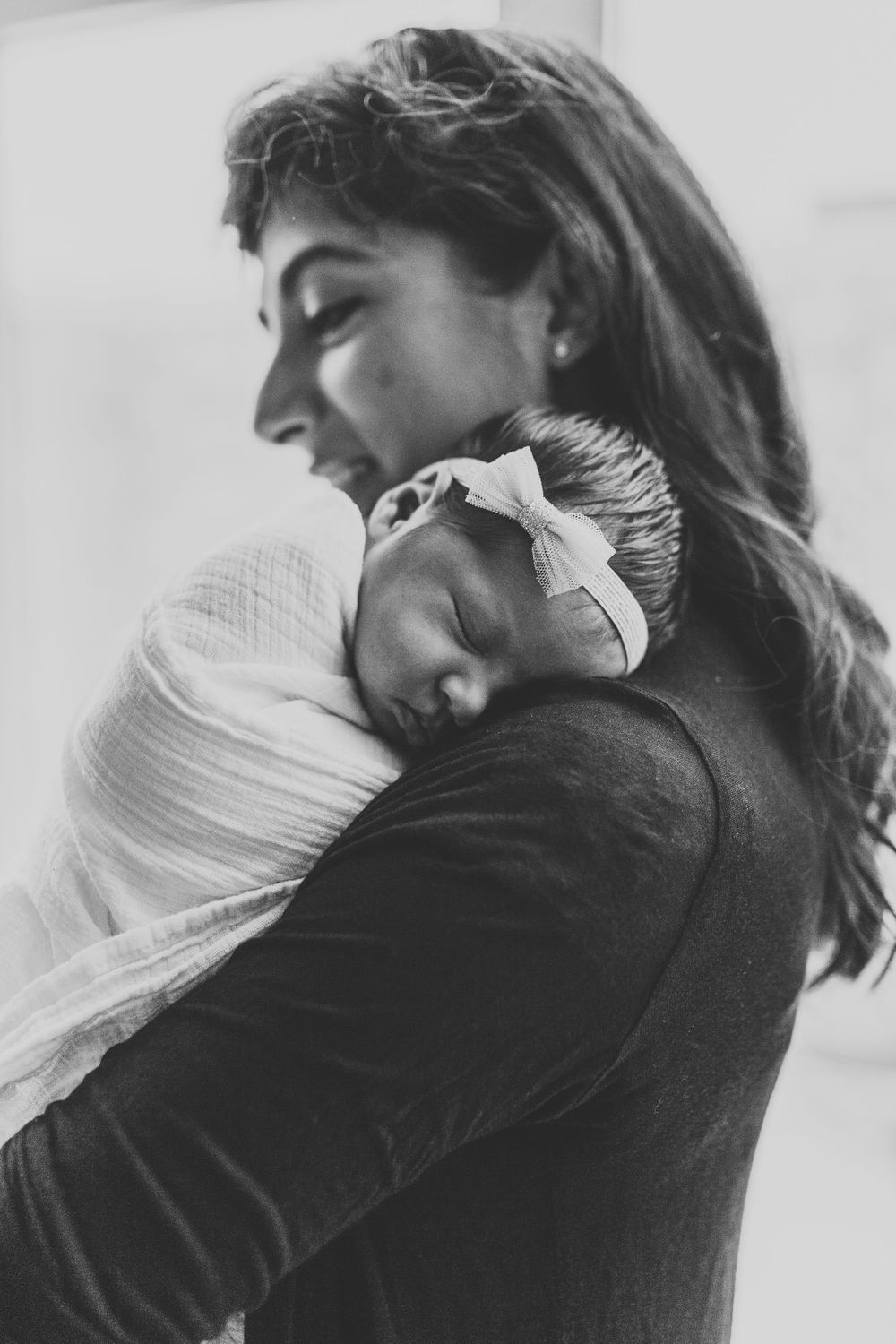 Mother holding her daughter during Chicago newborn lifestyle session