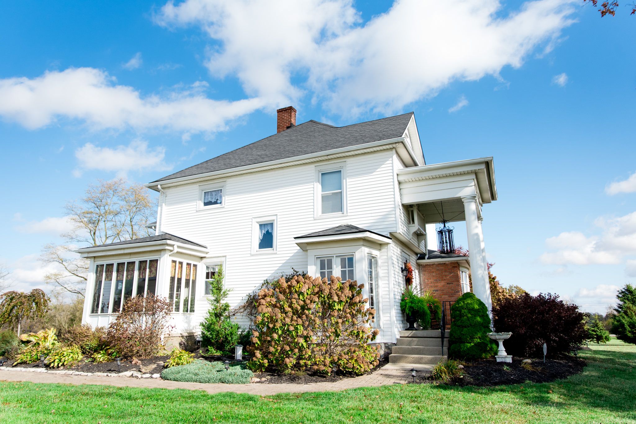all white house with blue cloudy sky - the Shepard's Place in Ohio