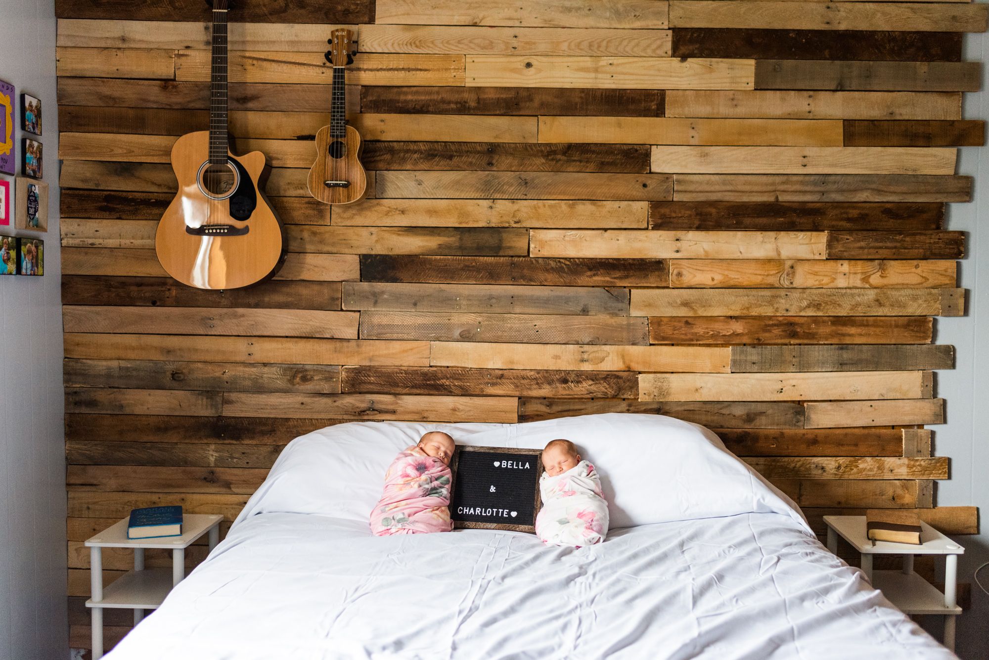 Newborn twin girls laying on bed with name sign in Corsica, Pennsylvania