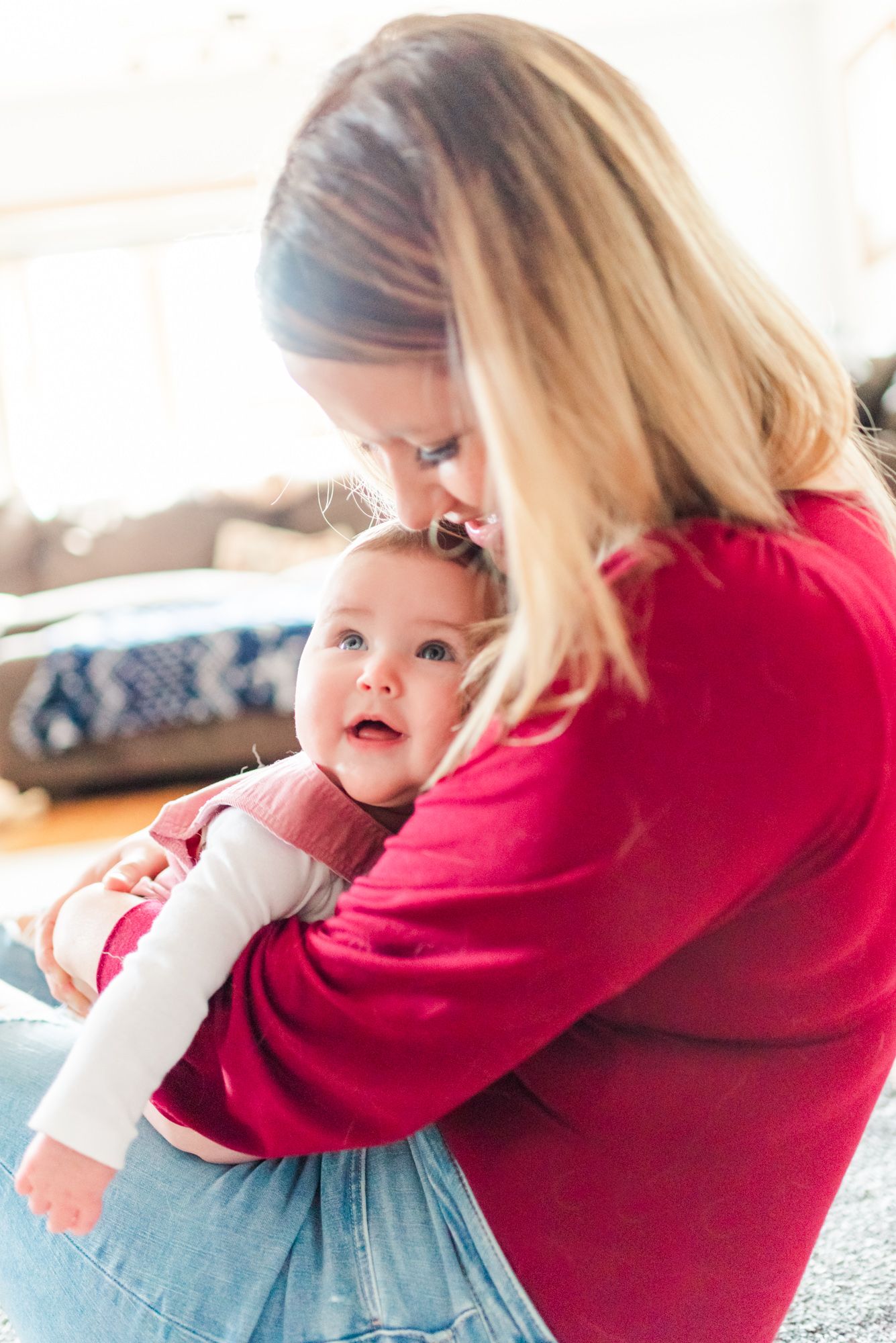 Lifestyle family photoshoot in the home with mom holding 6 month old baby in Gibsonia, Pennsylvania