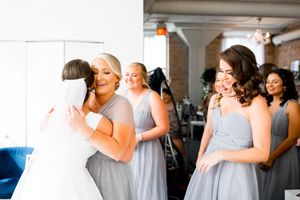 Bride does a first look with her bridesmaids at Room 1520 wedding in Chicago
