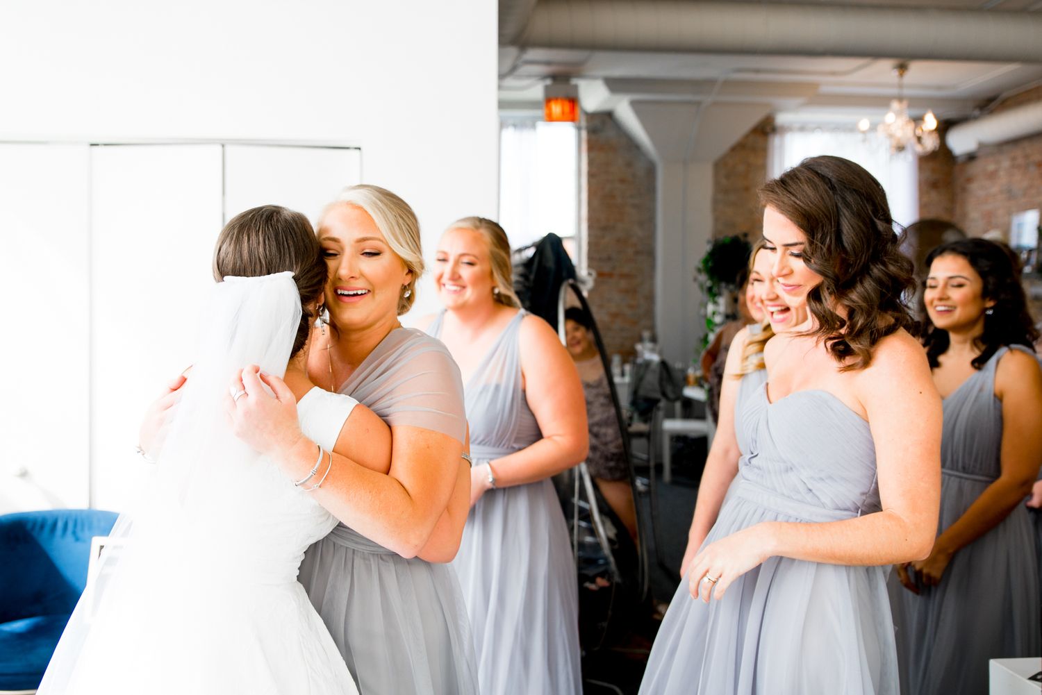 Bride does a first look with her bridesmaids at Room 1520 wedding in Chicago