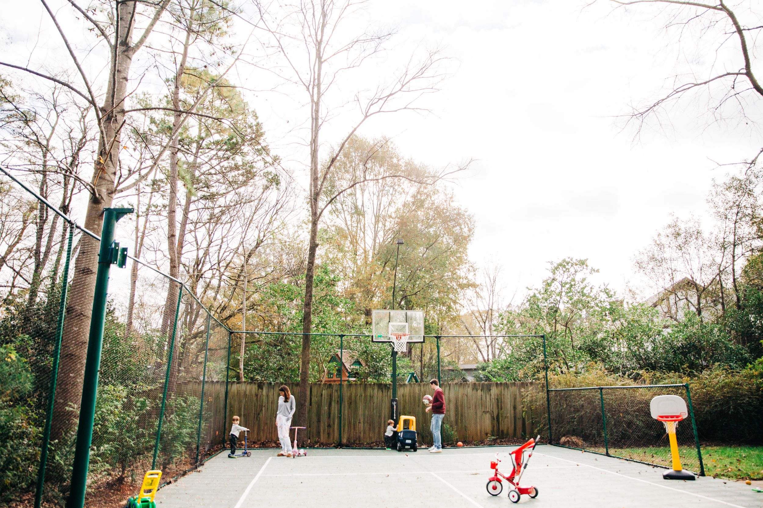 Family of four playing on the basketball court in their Charlotte, NC home