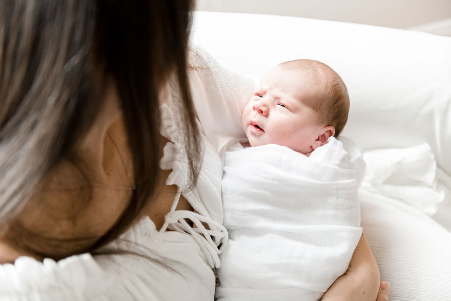 Mother gazes down at newborn baby