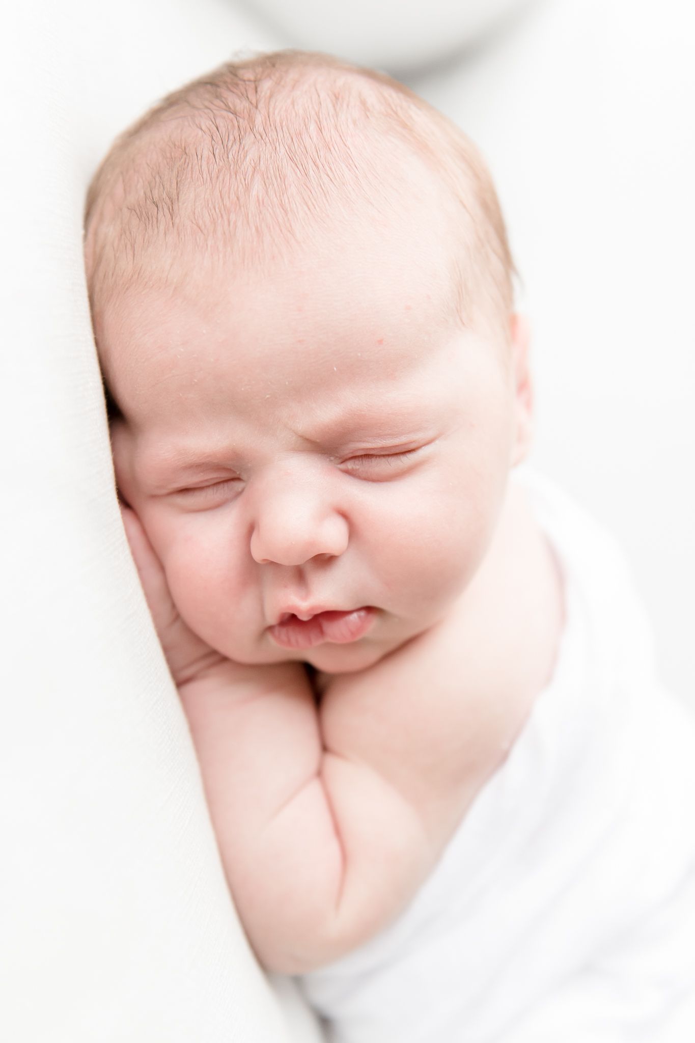 Newborn baby sleeps in her rocking chair