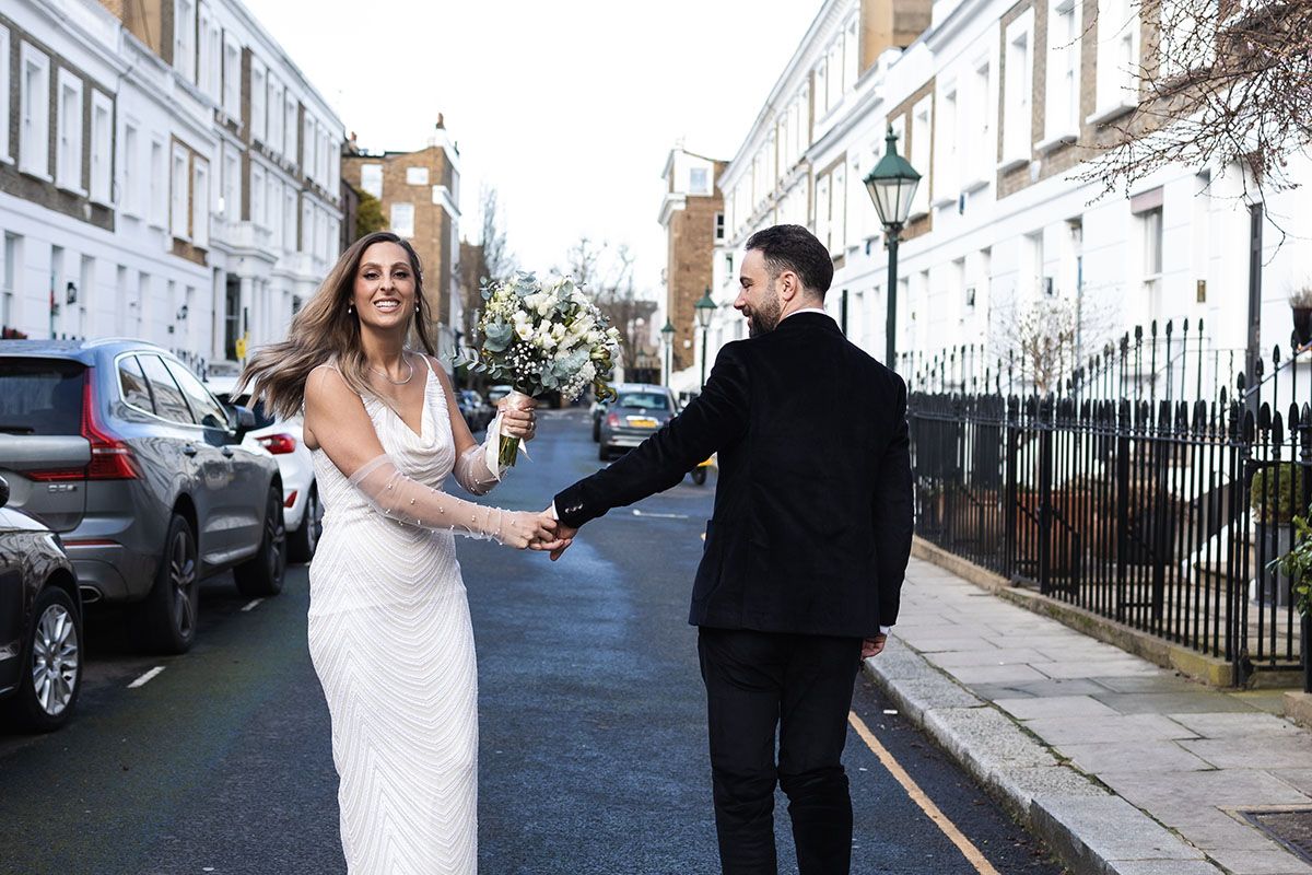 Bride and groom dancing in the streets.