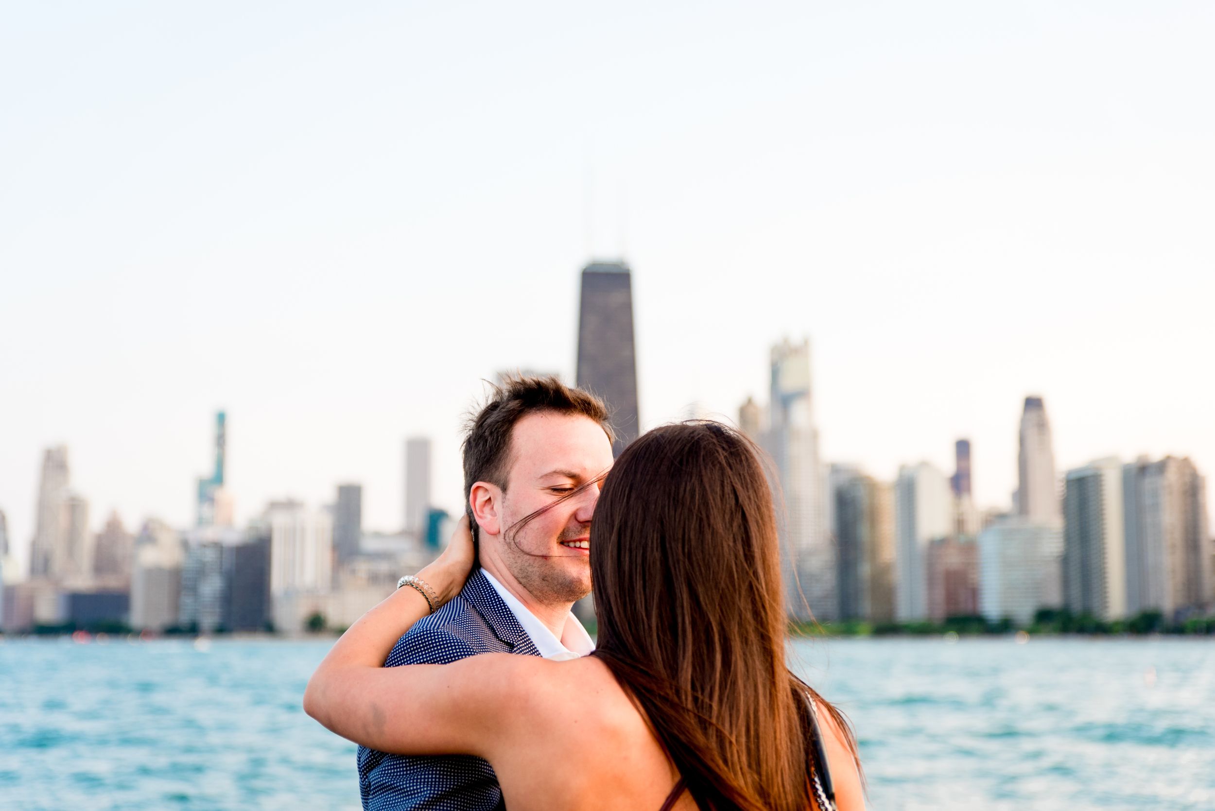 man and woman hugging after Chicago proposal at North Avenue Beach pier