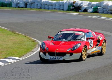 lotus sports car takes a corner on the 3 sisters track