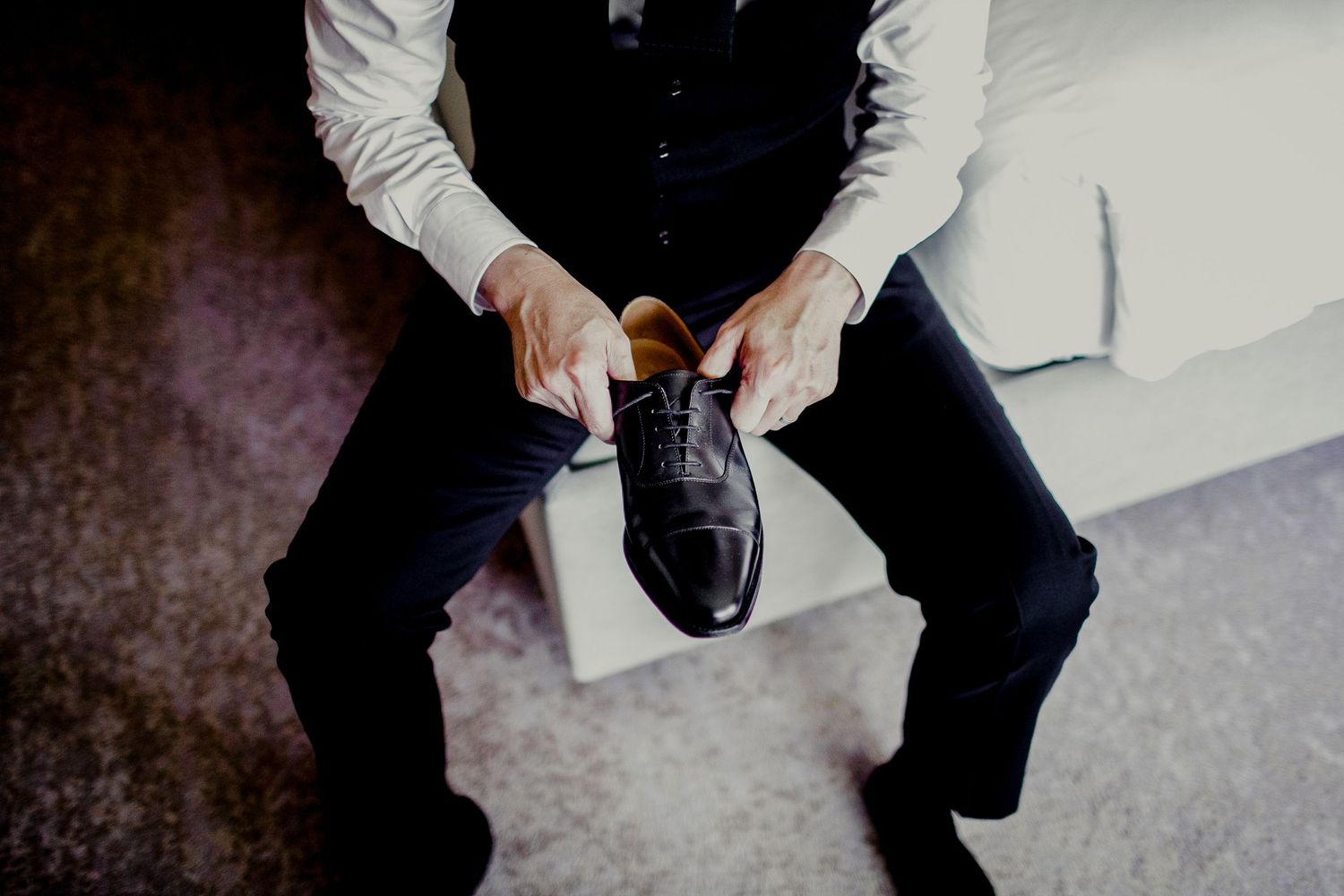 groom adjusting shoes to put on