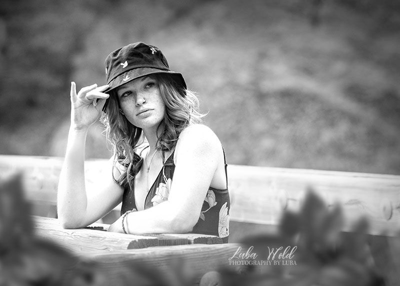 hs senior girl wearing a hat on a bridge in Spokane black and white photographer luba wold