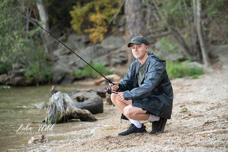 hs senior boy fishing by lake Coeur d'Alene photographer luba wold
