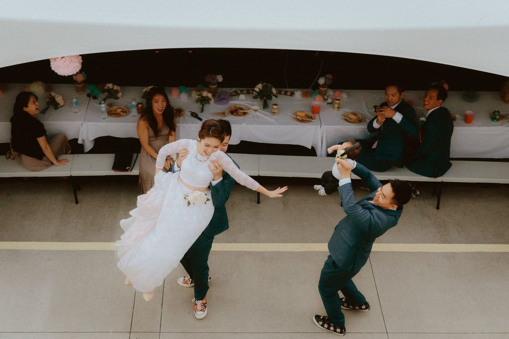 Wedding reception dance sequence showing playful moments on a polished dance floor.