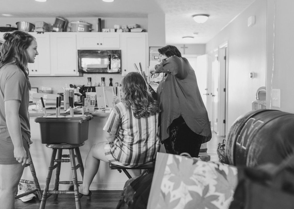 Interior scene of kitchen area with casual gathering.