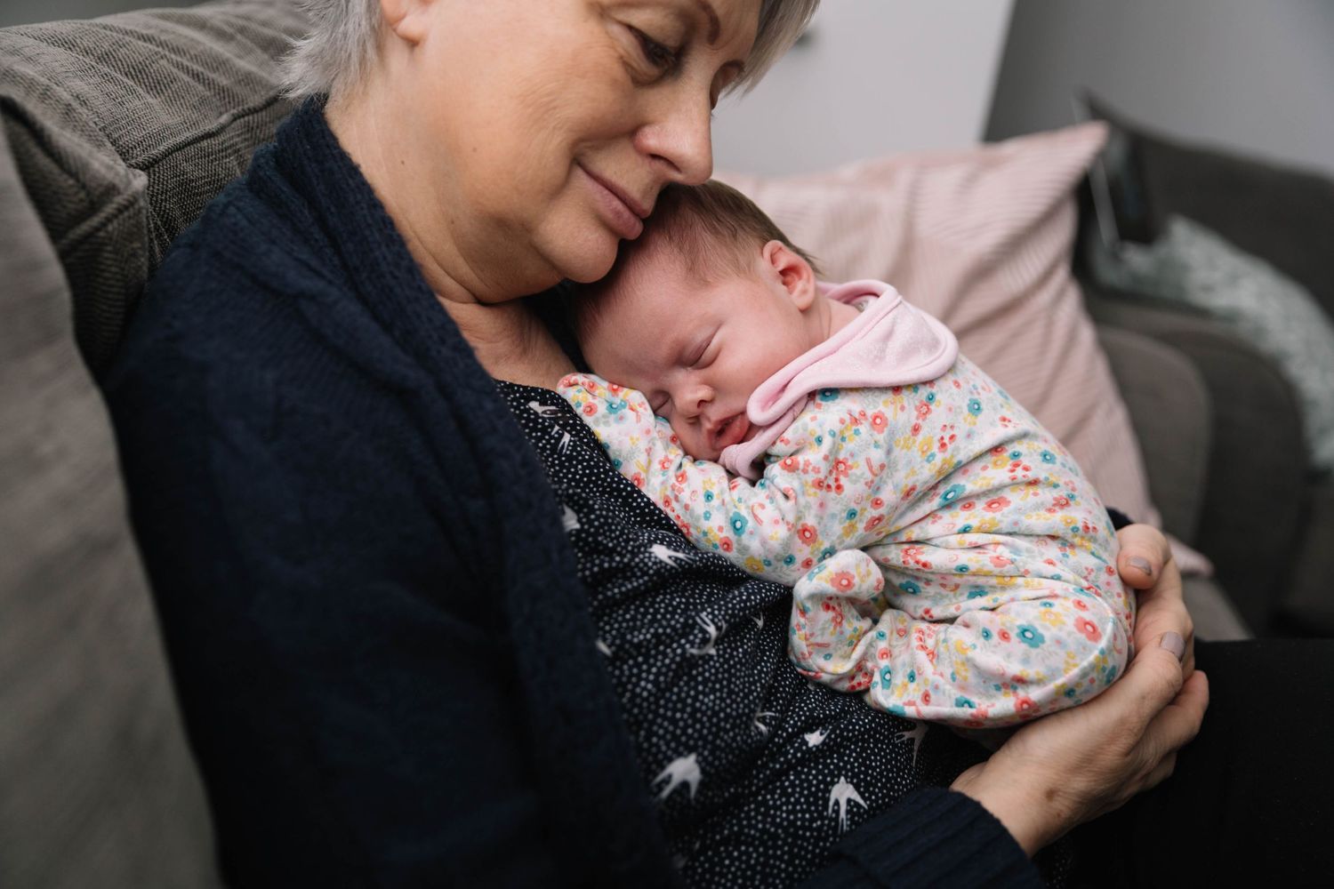 tiny baby girl resting on grandma chest