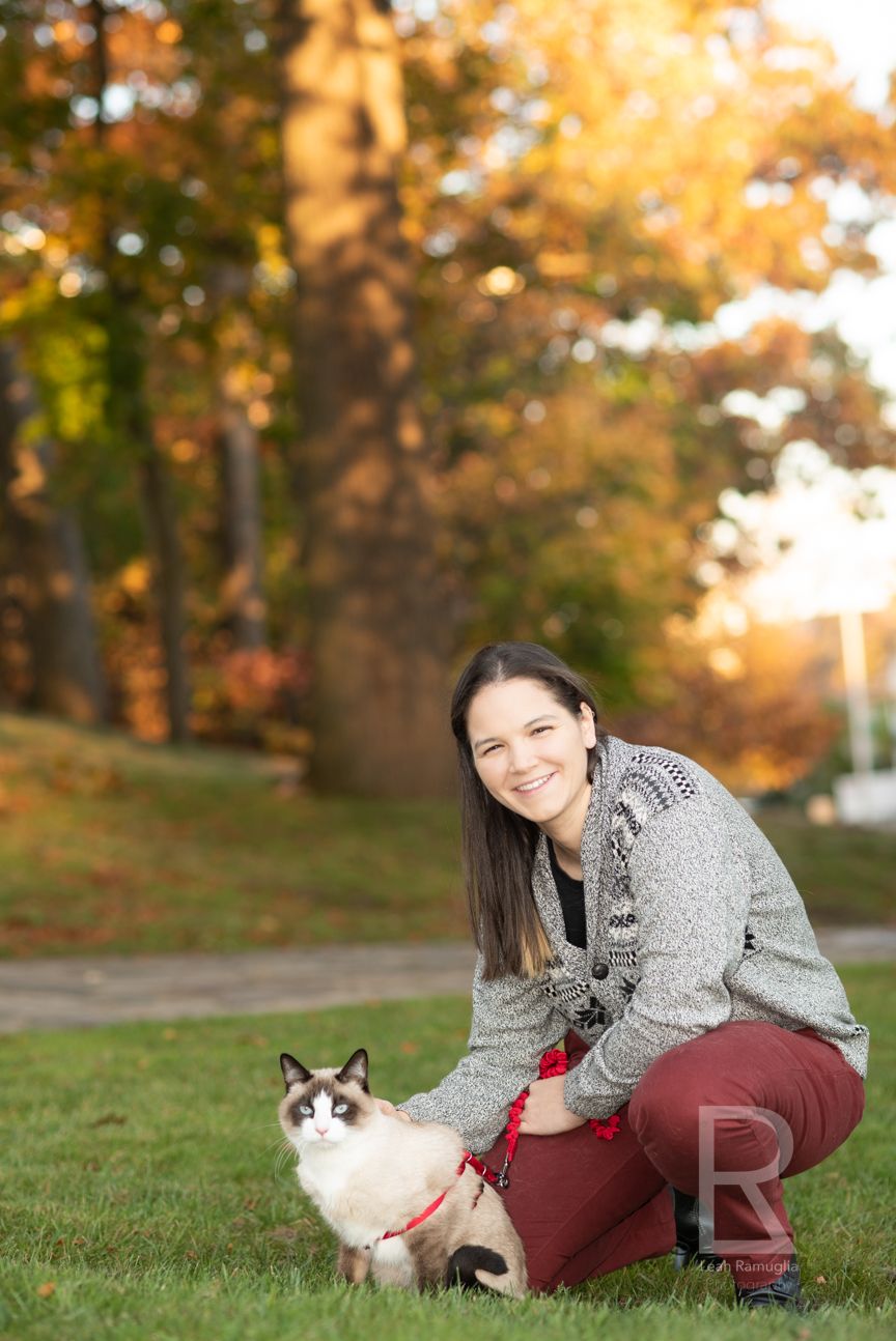 A woman and her cat enjoy New England fall foliage in Medford, MA