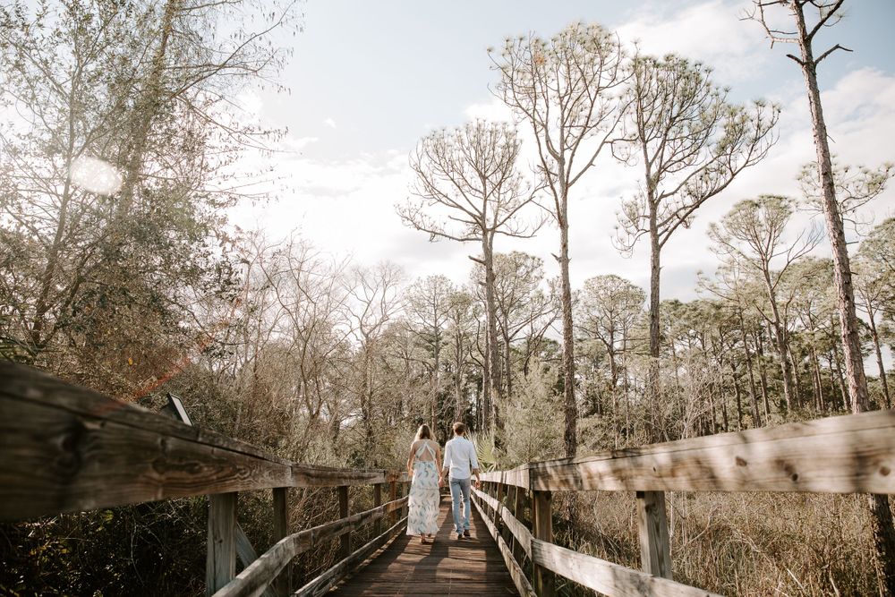 couple walking along a walkway in a local Destin, Florida park