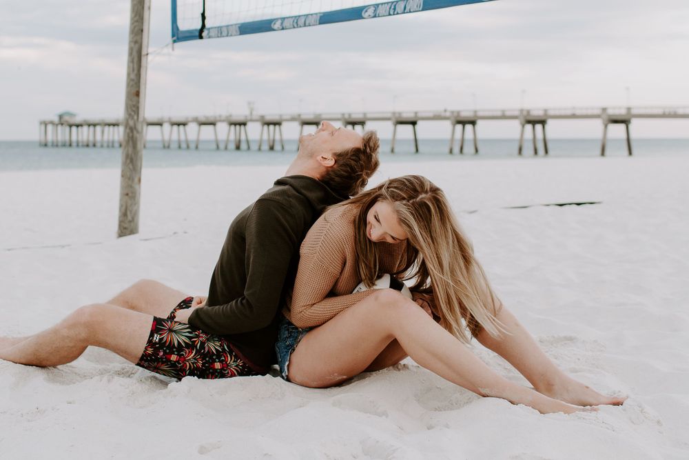 man leaning against his parter as he is laughing