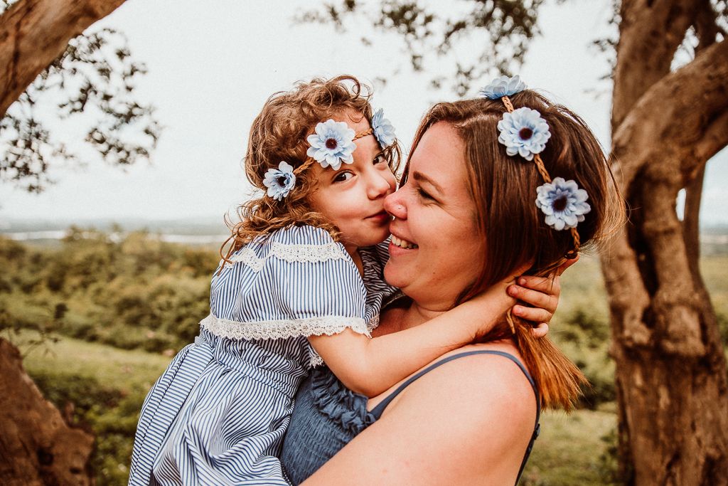 girl kissing her mother on the nose