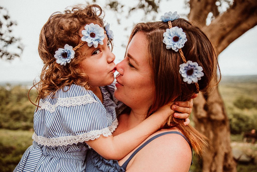 daughter kissing her mother on the nose