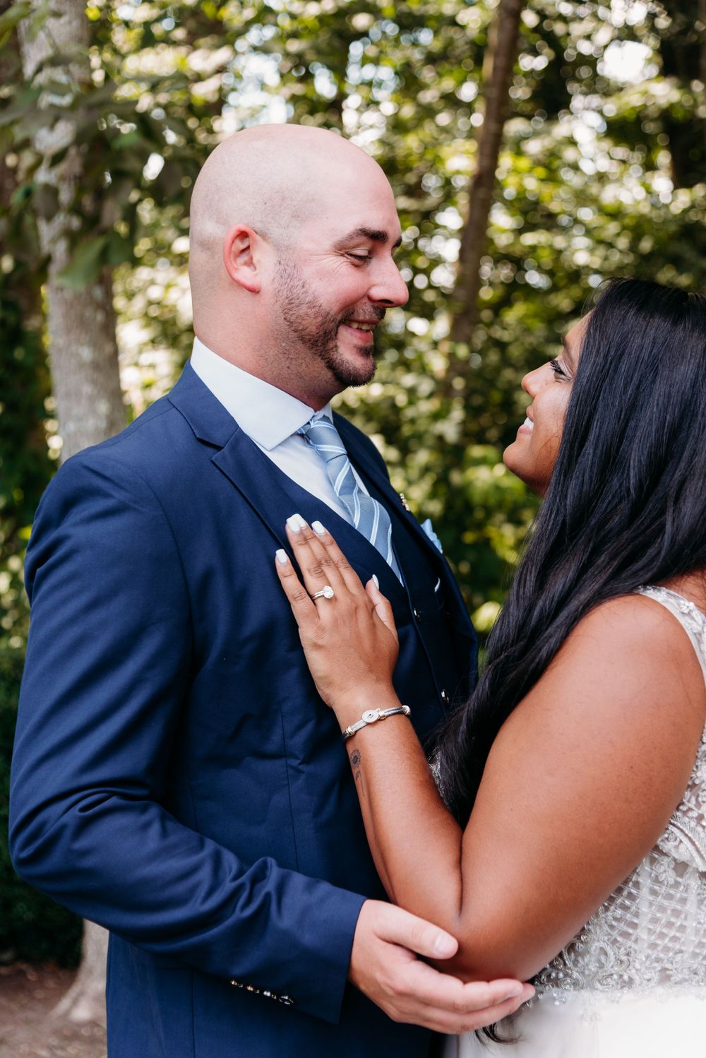A tender moment between newlyweds as they share an intimate embrace outdoors.