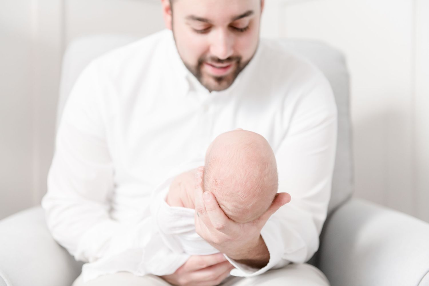 First time father lovingly holds his son