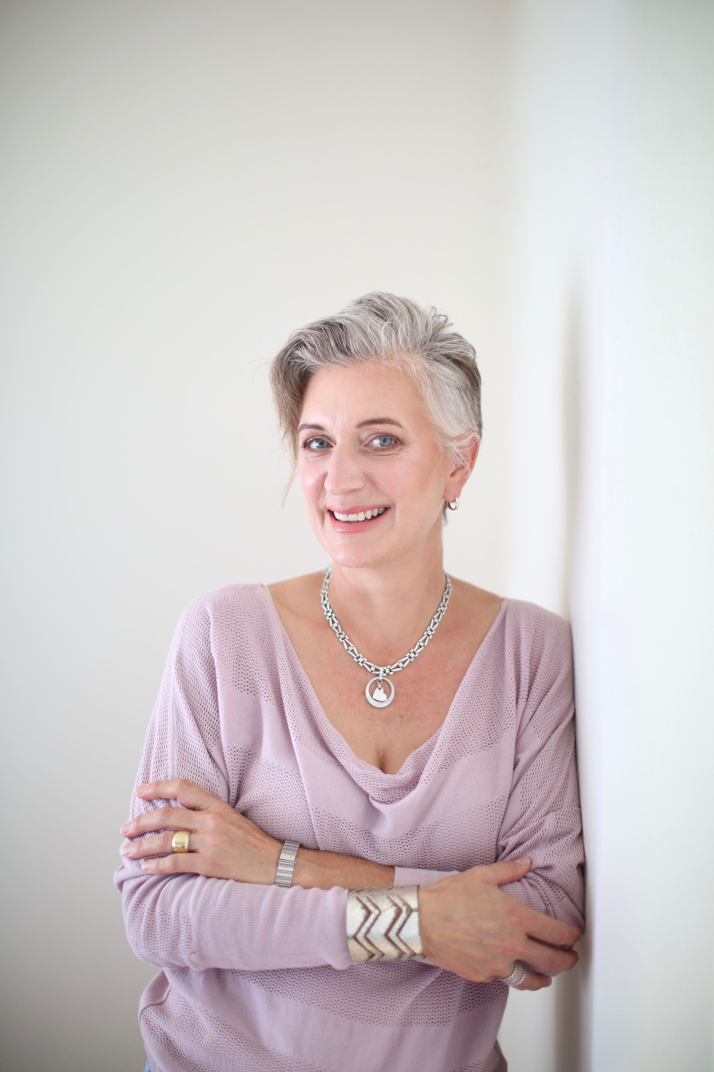 woman in moouve poses for a headshot with arms crossed