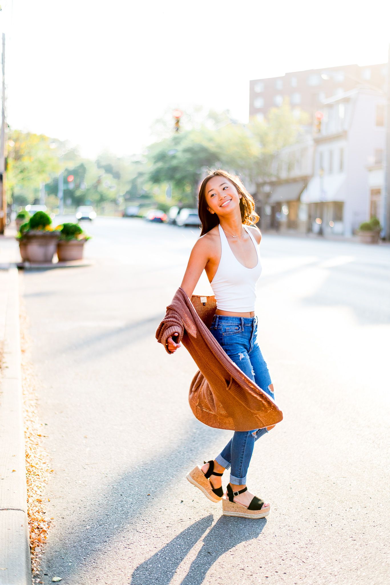 high school senior girl twirling in the street