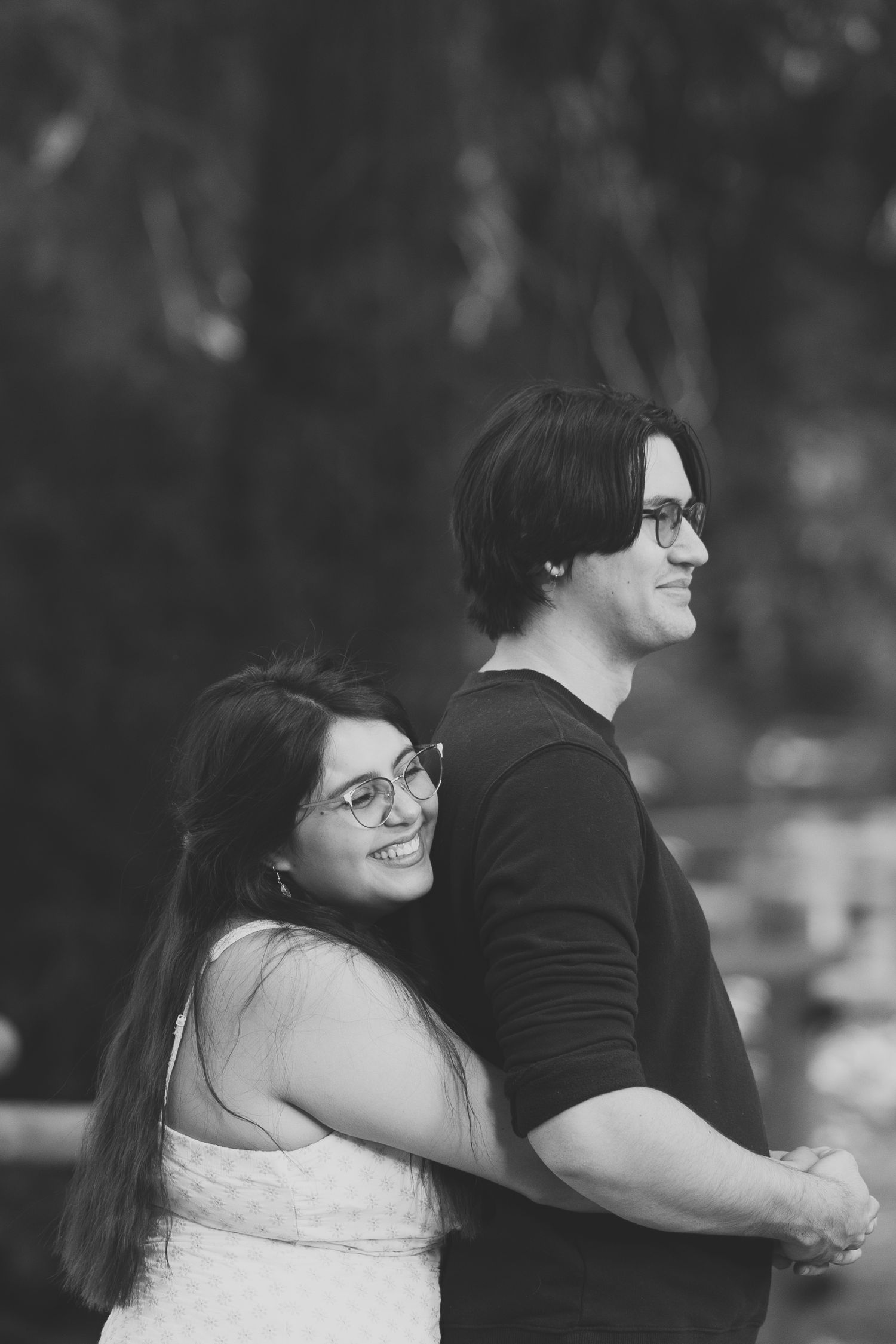 girl hugging partner from behind while smiling