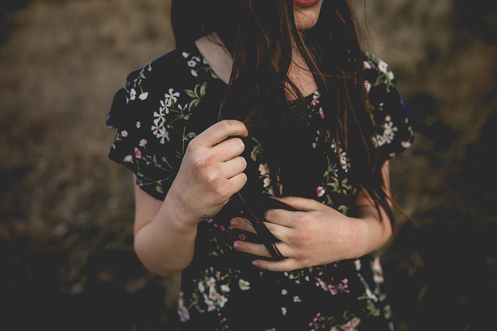 after image of girl running finger through hair