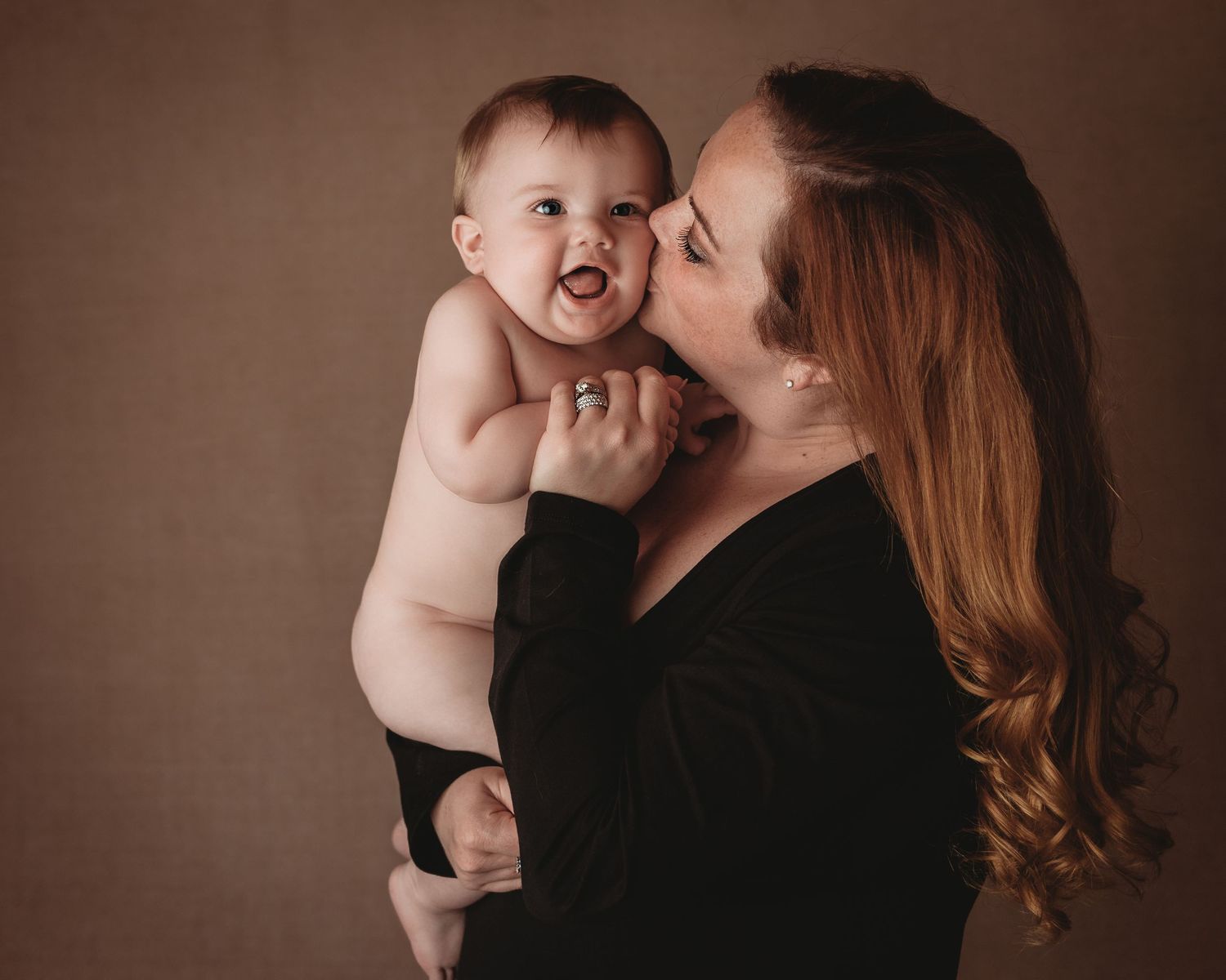 smooching baby black bodysuit mom and son motherhood session studio