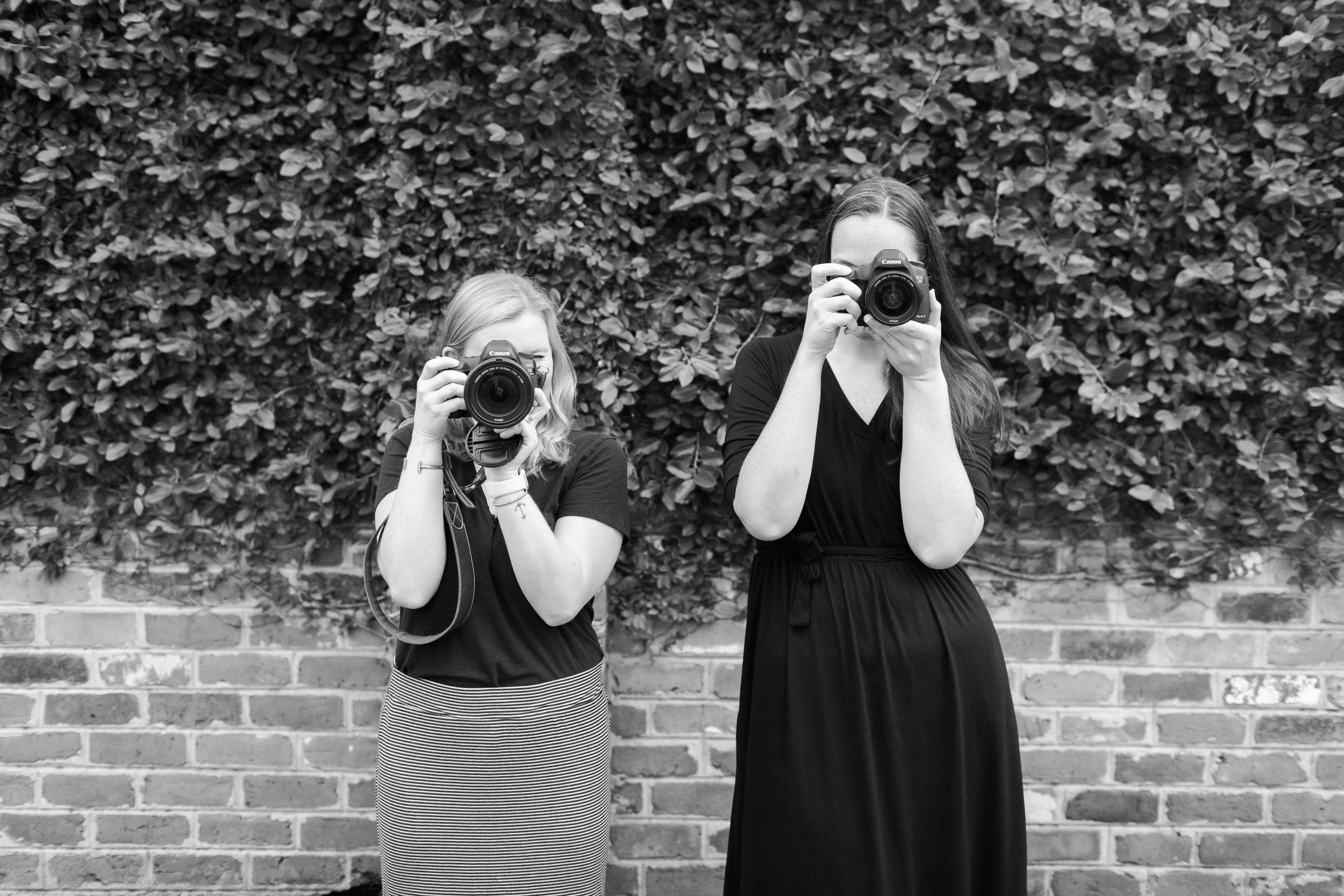 portrait of two photographer taking a photo of someone