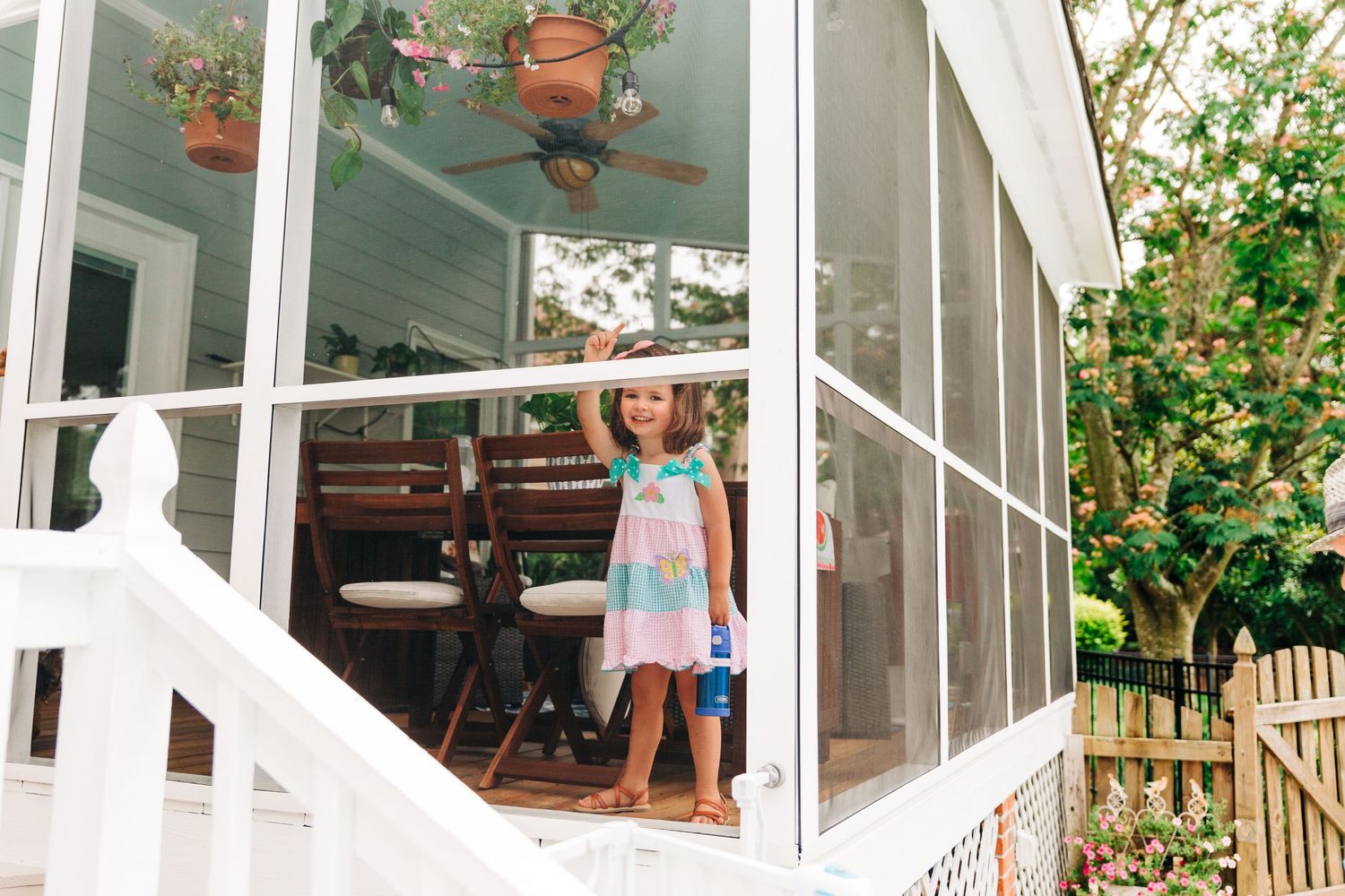 Preschooler playing on porch for backyard family photography session in Charlotte, NC