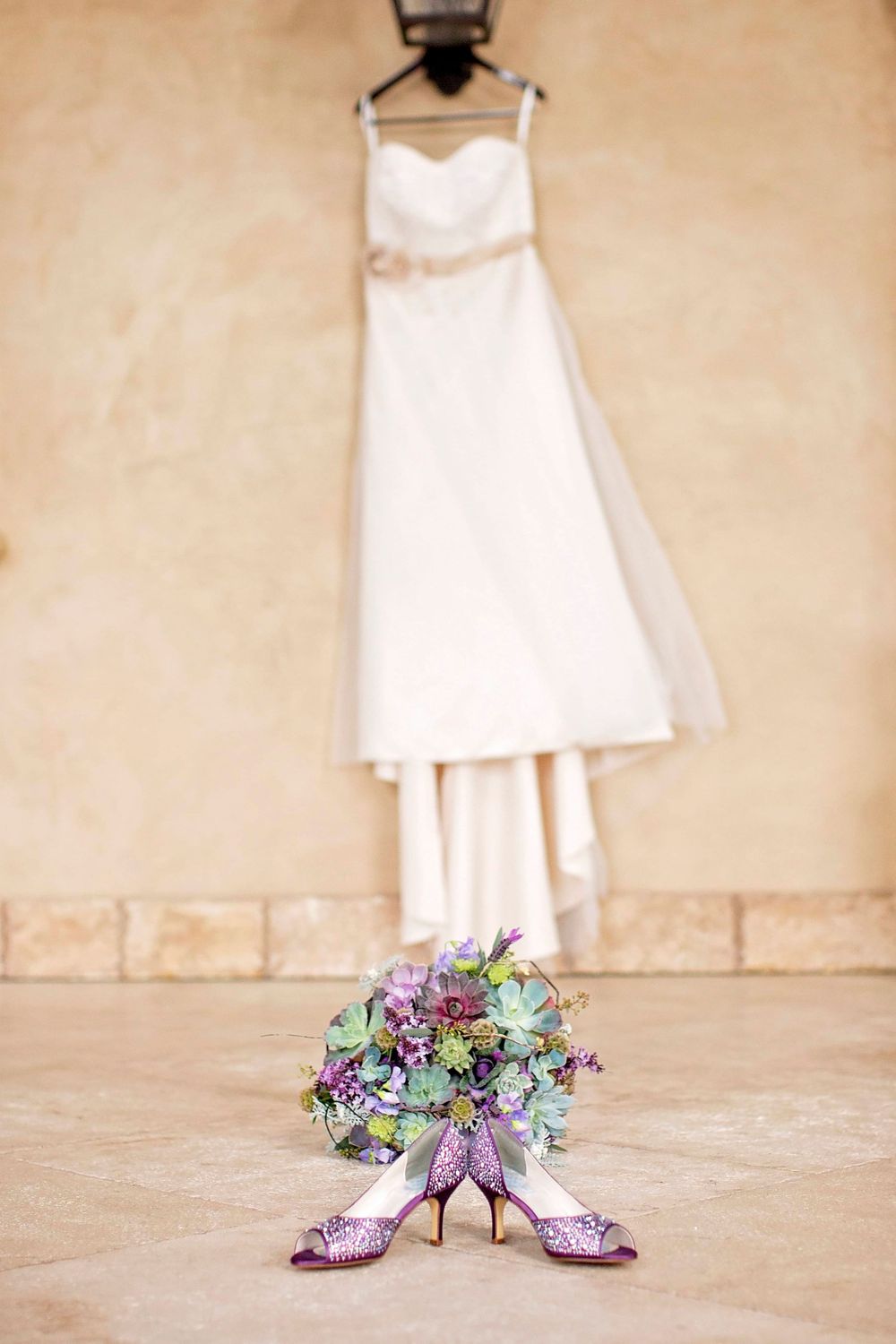 Wedding dress with wedding shoes and bridal bouquet at Allegretto Vineyard Resort