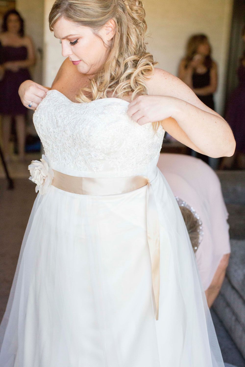 bride putting on wedding dress at Allegretto Vineyard Resort