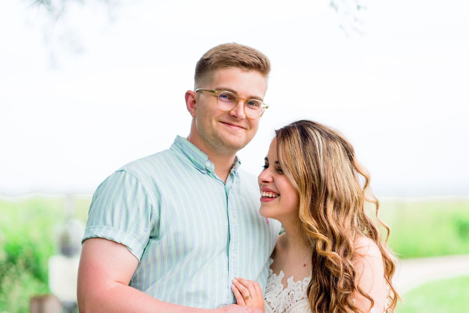 young engaged couple laughing at Montrose Harbor in Chicago at sunrise