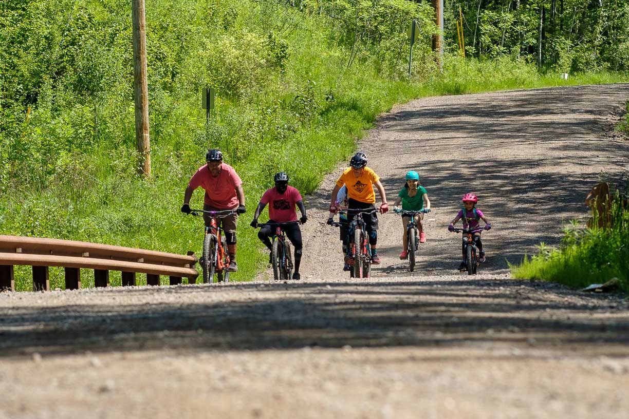A family mountain bikes together at spirit mountain in Duluth Minnesota