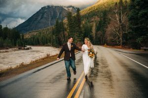 Couple running along the going to the sun road in glacier national park
