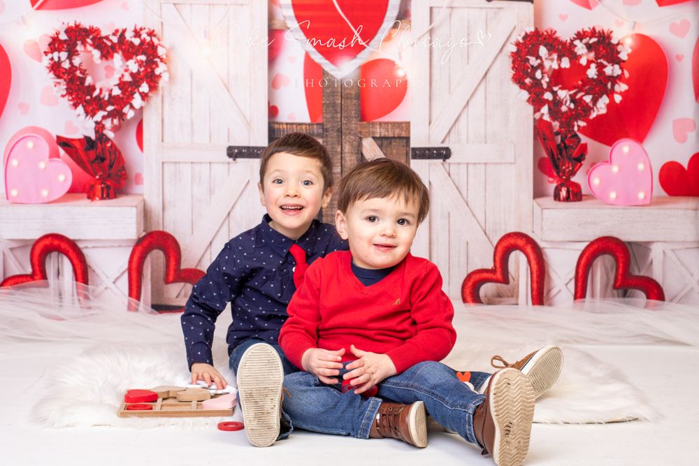 A smiling girl dressed in Valentine's Day-themed outfits posing for the camera during a Valentine's mini