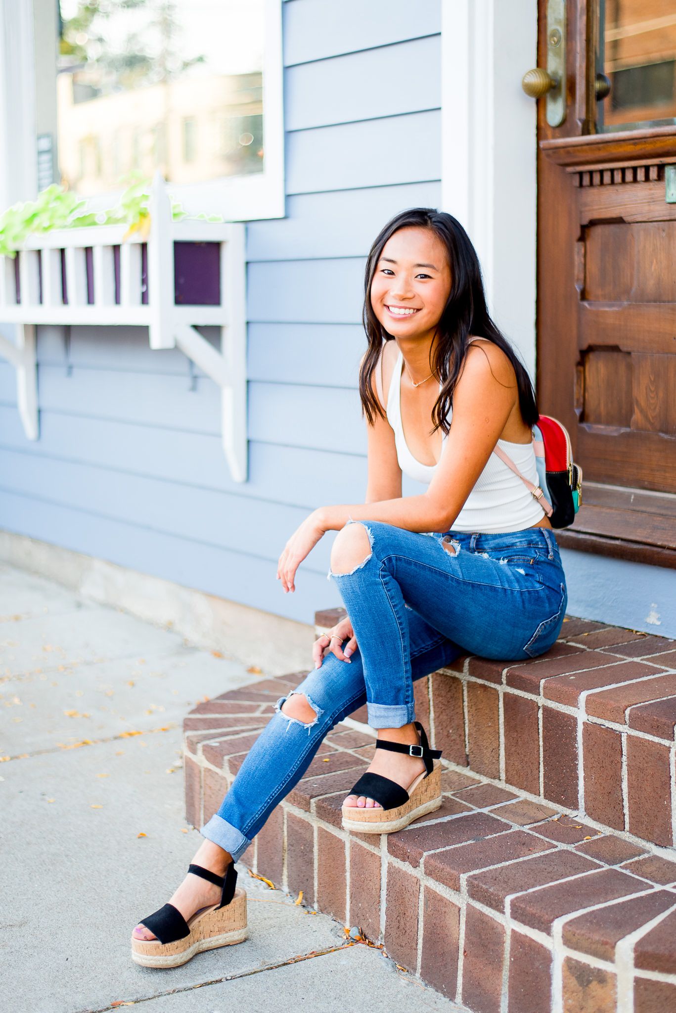 high school senior girl sitting on a stoop in downtown Cincinnati