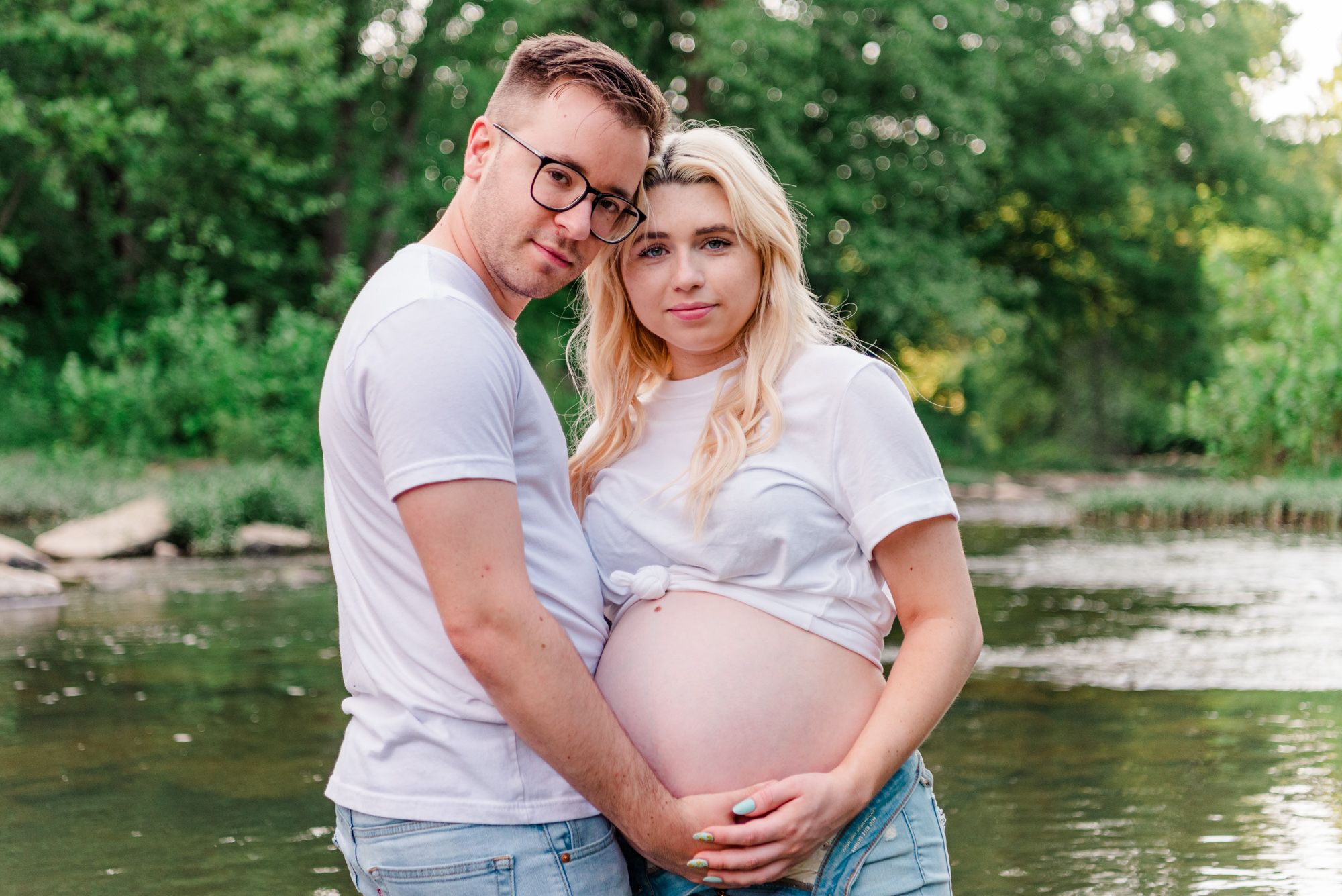 Hipster maternity photos in jeans and white shirt in stream in Zelienople, Pennsylvania