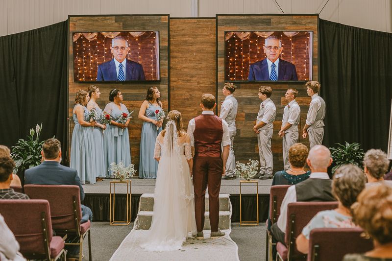 A bride and groom stand together during their ceremony at their Fort Morgan, Colorado Wedding.