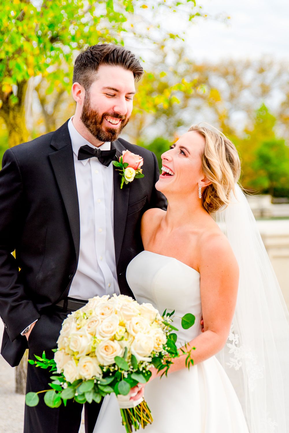 bride and groom laughing in wedding pictures in Forest Park at downtown STL