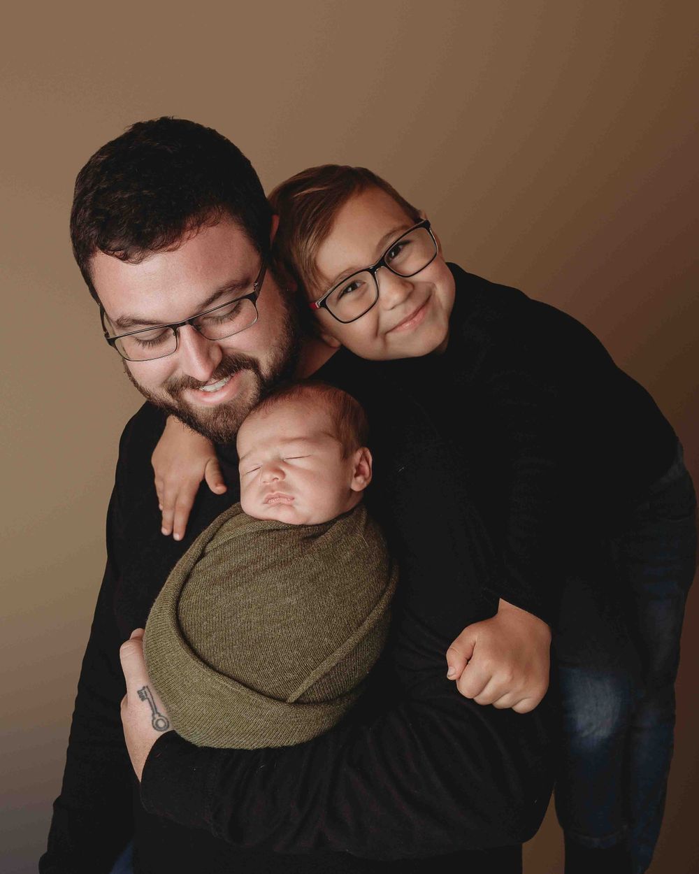 Professional newborn photo with dad and big brother