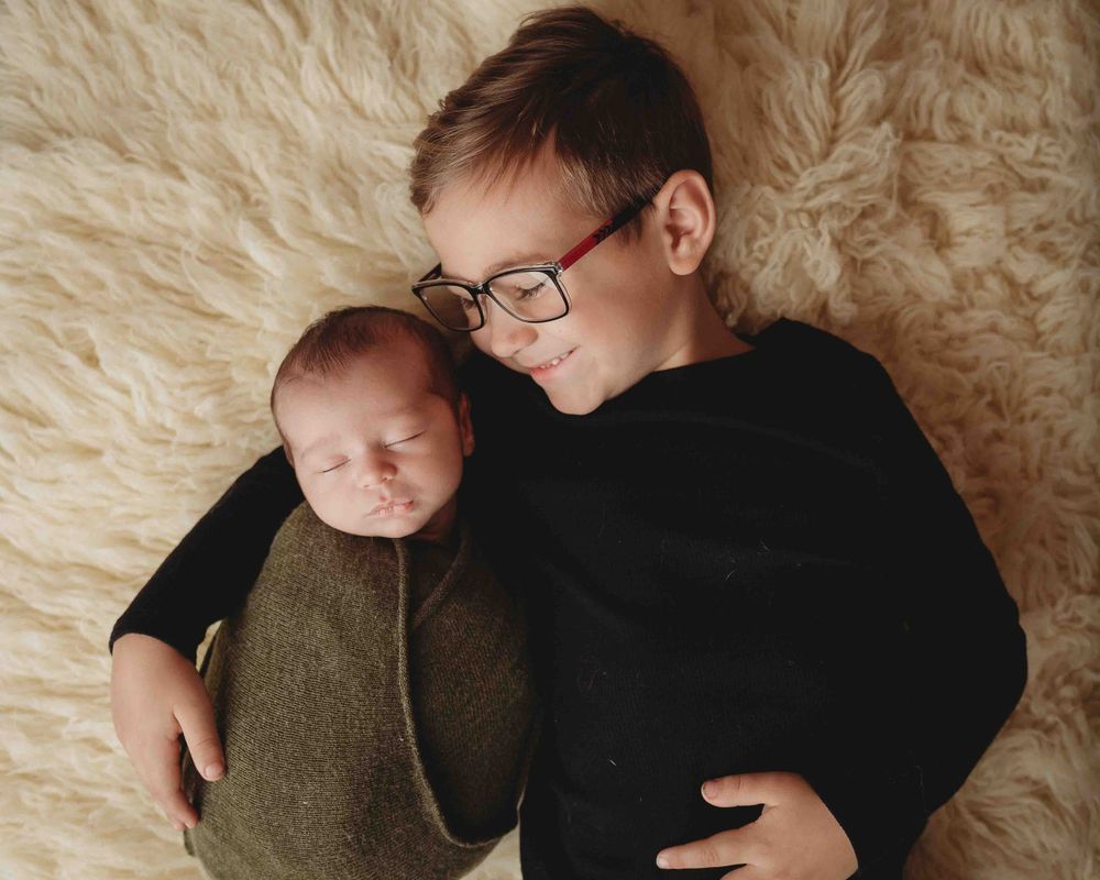 Professional newborn photo with big brother