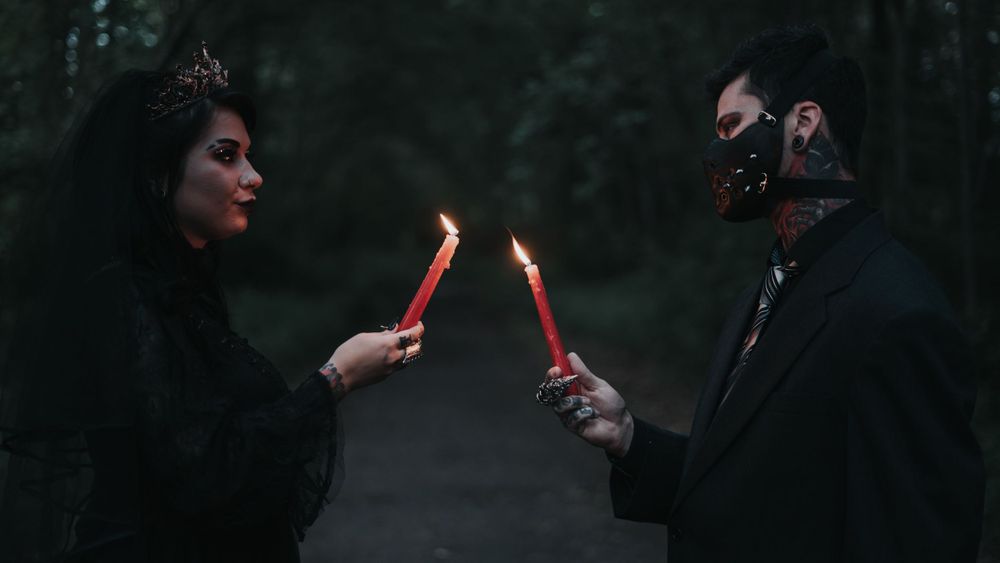 Black Dress Bride and Black dressed groom lighting each others red candles of unity photograph