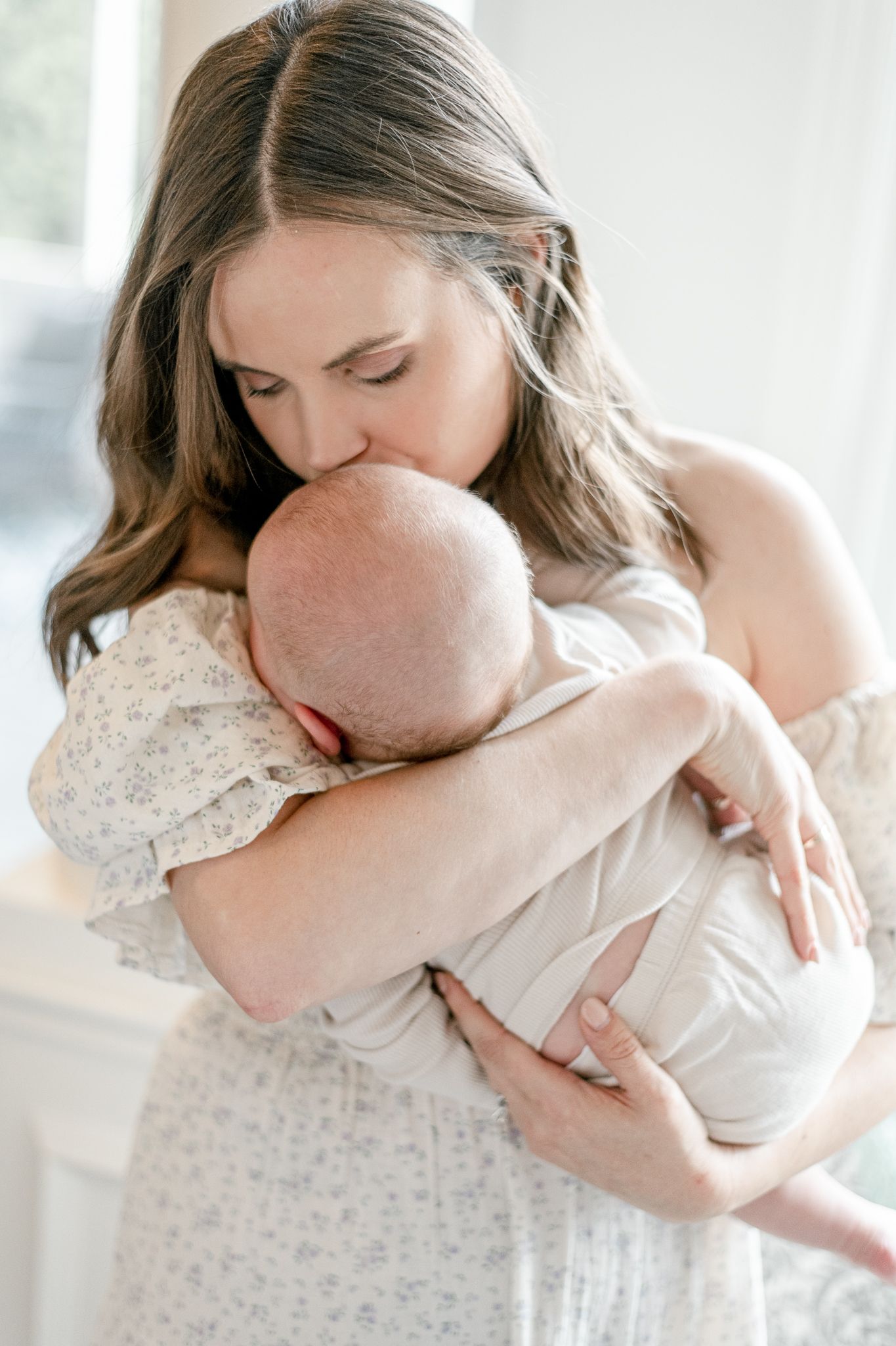 Mother kisses her baby's head