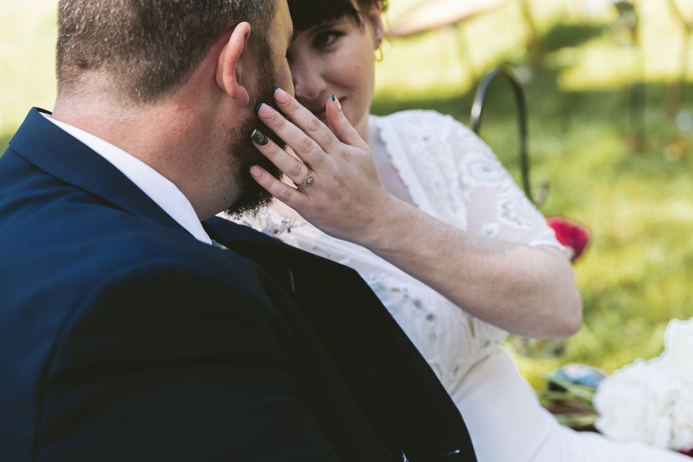 An intimate wedding moment captured in soft natural lighting outdoors.
