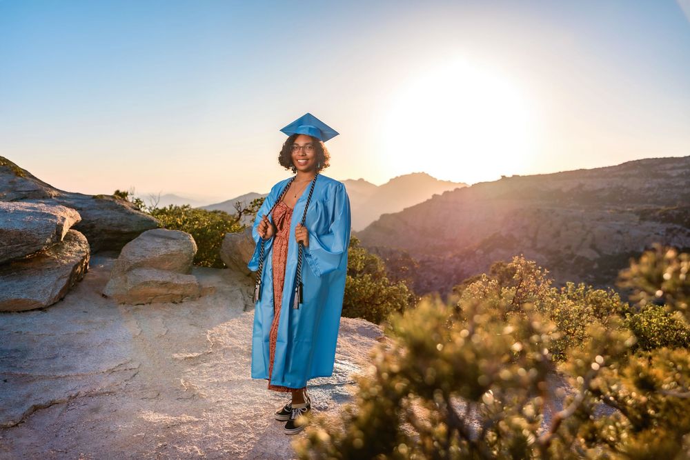 Golden hour senior photo overlooking cliffs at Windy Point, Tucson