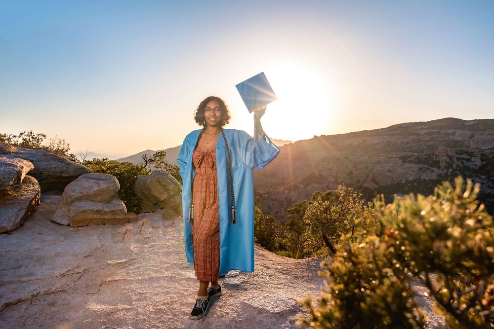 Golden hour senior photo overlooking cliffs at Windy Point, Tucson