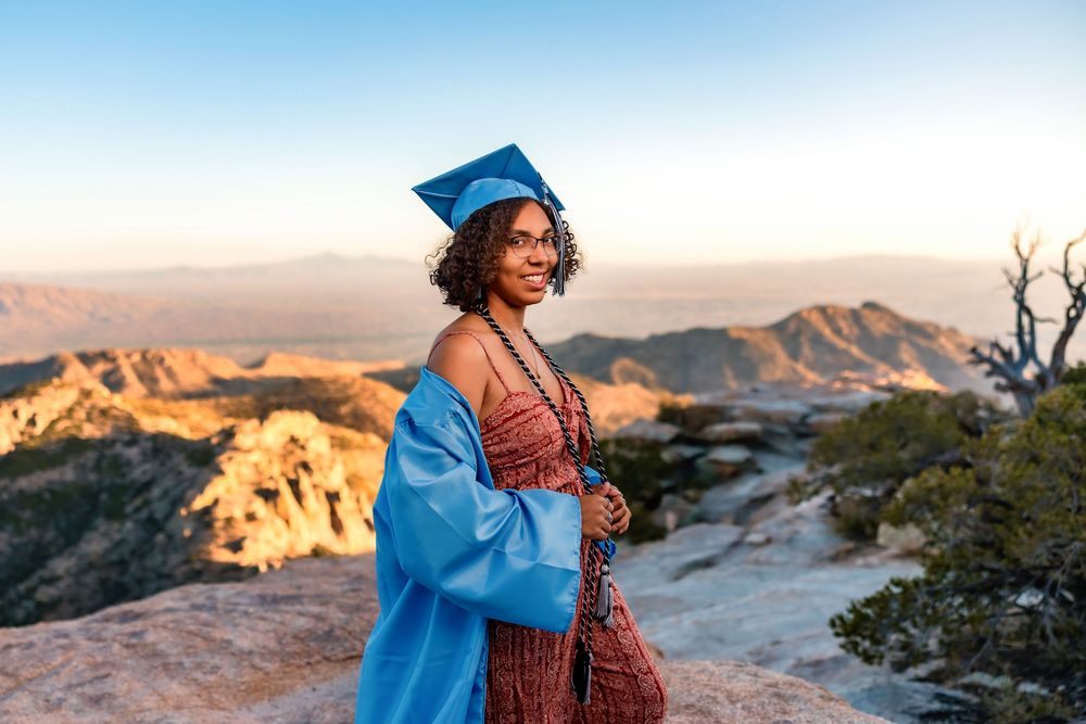 Golden hour senior photo overlooking cliffs at Windy Point, Tucson